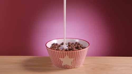 Milk Being Poured over Cereal in Bowl