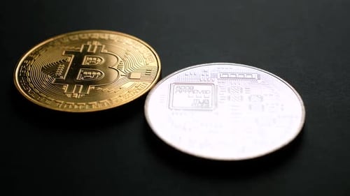 Shiny Gold and Silver Bitcoins on Black Surface