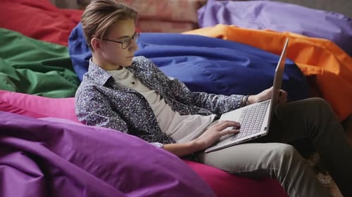 Young Adult Working on Laptop at Home