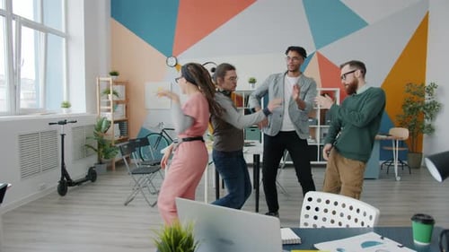 Carefree Office Workers Girl and Guys Dancing in Workplace Having Fun Together