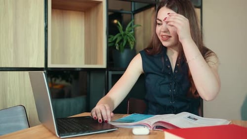 Young Woman Studying on Laptop Indoors