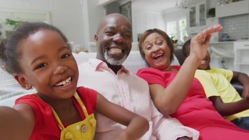 Happy Family Waving and Smiling at Camera