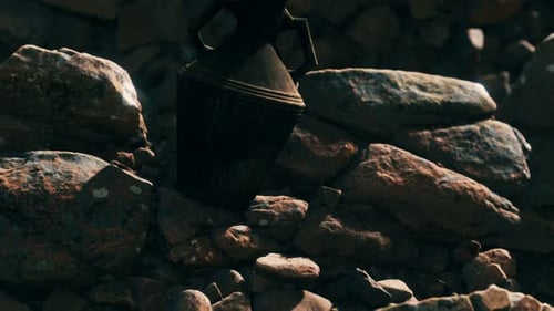 Old Metal Jug at Rocks