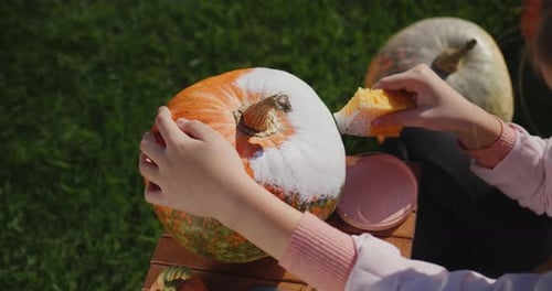 A Child Decorates a Pumpkin Prepares Festive Decorations