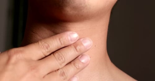 Hand Gently Manipulates Skin of Neck