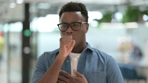 Adult Man Coughing in an Office