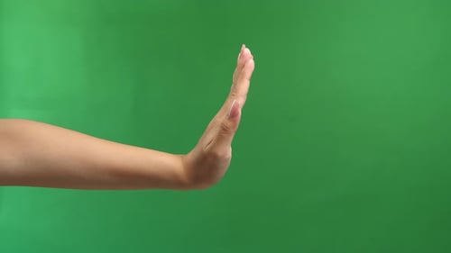 Woman Hand Show Stop Sign Isolated On Green Screen Background