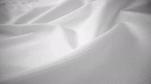 Shiny flowing cloth texture dolly shot in close up view macro shot.