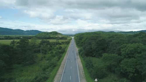 Aerial View Above Cars Driving Along Empty Countryside Road on Sunny Day