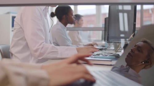 Female Call Center Operators Working in Office