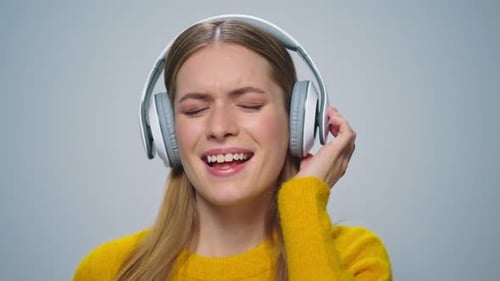 Smiling Woman Listening to Music Wearing Headphones
