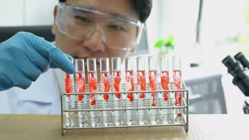 Scientist experimenting chemicals in science laboratory