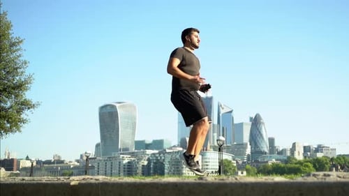 Man Exercising with High Knees in Urban Setting