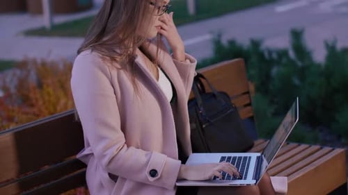Concentrated Beautiful Woman Typing on Laptop and Doing Remote Work in Park