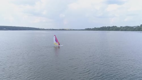Windsurfer sailing on a lake