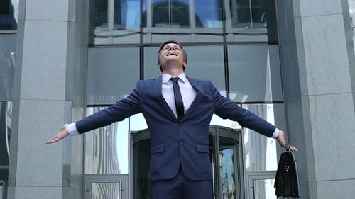 Successful Businessman Reaches For the Sky in City