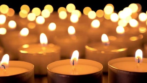 Many Lit Candles Glowing in the Dark