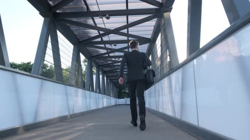 Stylishly Dressed Manager with a Briefcase Rushes to Work