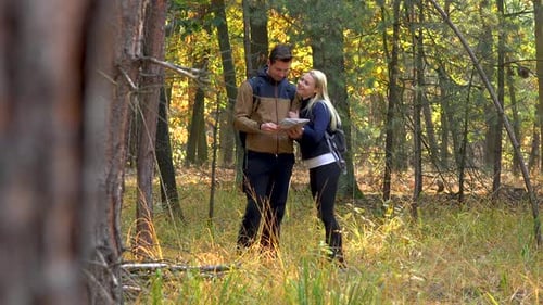 Couple Navigating With a Map While Hiking