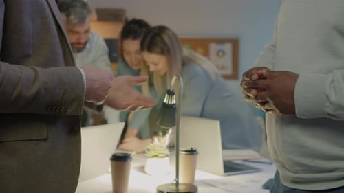 Entrepreneurs Men Gesturing Then Shaking Hands Making Deal Indoors in Dark Office