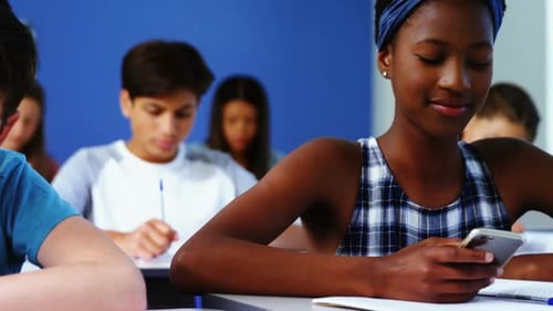 Student using mobile phone in classroom