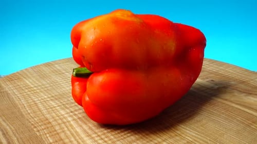 Fresh Red Bell Pepper Rotating on Cutting Board