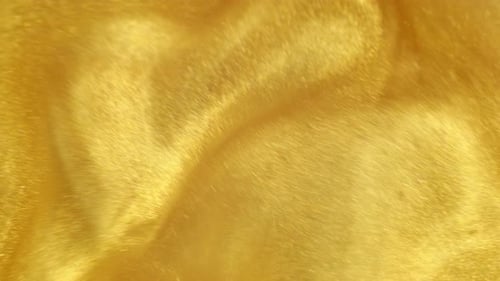 Swirling Liquid Gold Paint Abstract Background