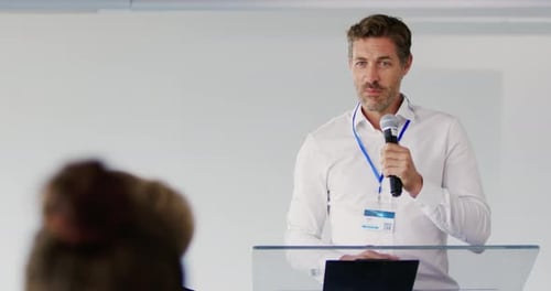 Confident Man Giving Speech at Corporate Conference