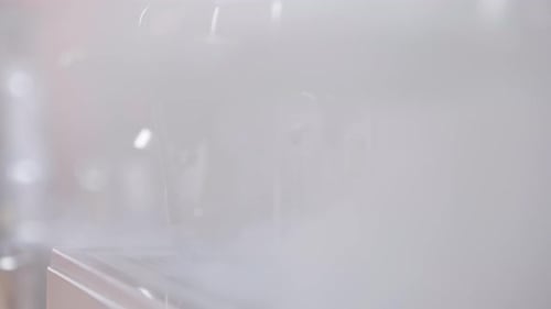 Steaming Espresso Machine Close-up in Workplace