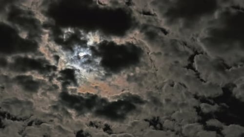 Clouds Float Across the Starry Night Sky