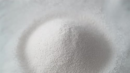 Pile of White Powder with Falling Particles