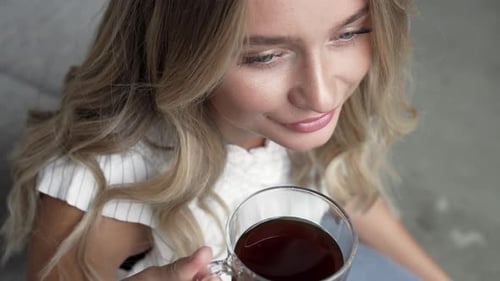 Woman Drinking Coffee at Home, Close Up Portrait