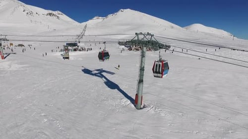 Panoramic View of Poma Lift with Cabins on Mountain Ski Resort with People in Slowmotion