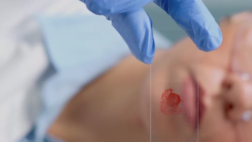 Vertical Video Close Up of Hand Holding Glass Tray with Blood