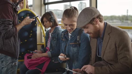 People Using Technology on City Bus