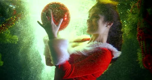 Woman Underwater with Christmas Ornament and Decorations