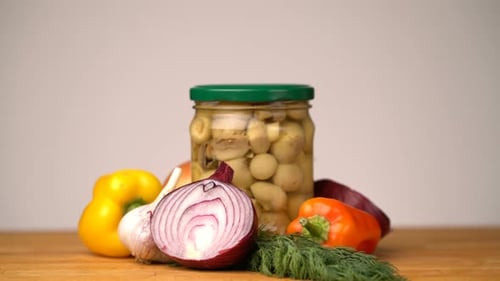 Footage Glass Jars with Salted Vegetables for the Winter Rotated on Table