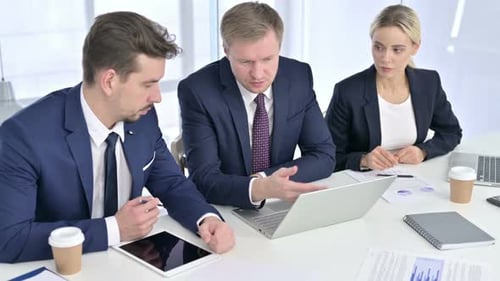 Colleagues Work Together at Meeting Table