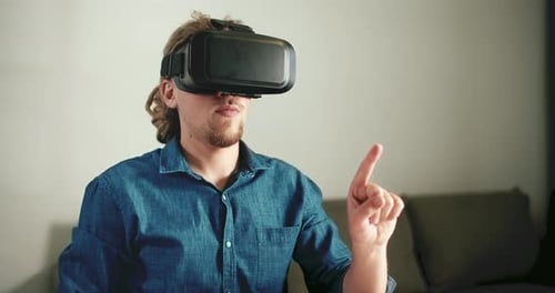 Man with VR Headset Gesturing with his Hands