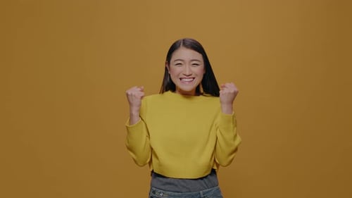Excited Person Clenching Fists to Celebrate Victory in Studio