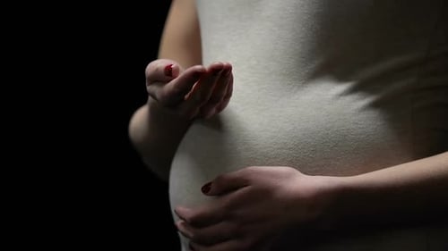 Pregnant Woman Holding Medicine in Hand