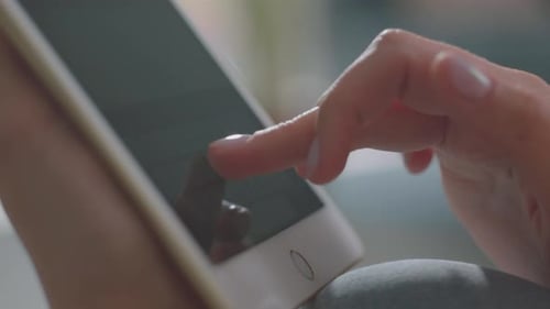 Woman Typing on Digital Tablet Touchscreen Close Up