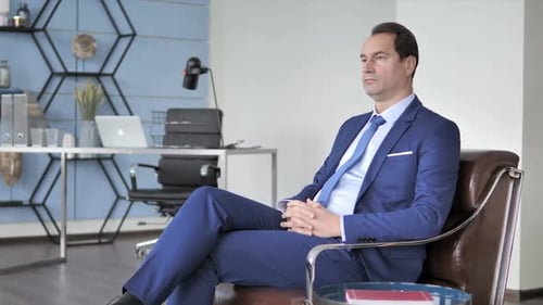 Pensive Middle Aged Businessman Thinking in Office