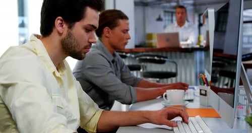 Business executives working over computer