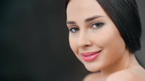 Sexy Smiling Woman Naked Soft Smooth Skin Posing at Black Studio Background Tilt Up