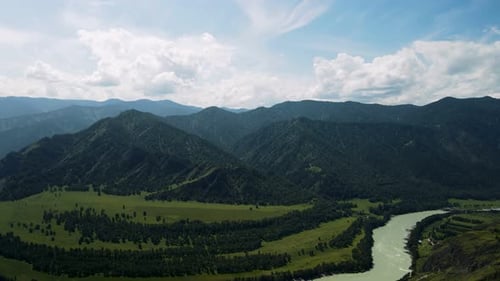 A Mountain River Against the Background of High Green Mountains
