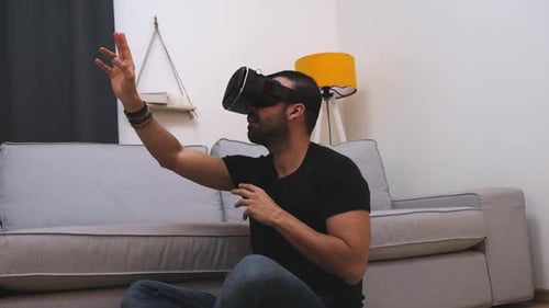 Man Using Virtual Reality Headset in Living Room