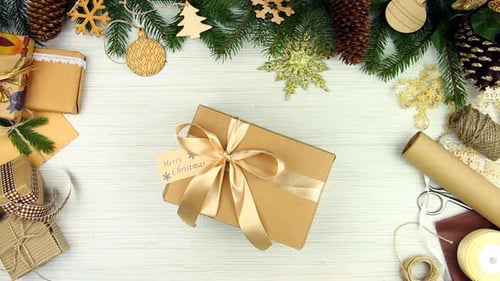 Hands Grab Christmas Gift with Holiday Decorations