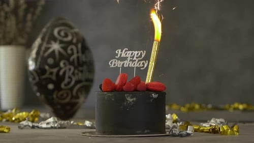 Black Birthday Cake with Sparkler and Confetti