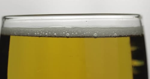 Cold Light Beer in a Glass. Craft Beer Close-up Macro. Rotation 360 Degrees